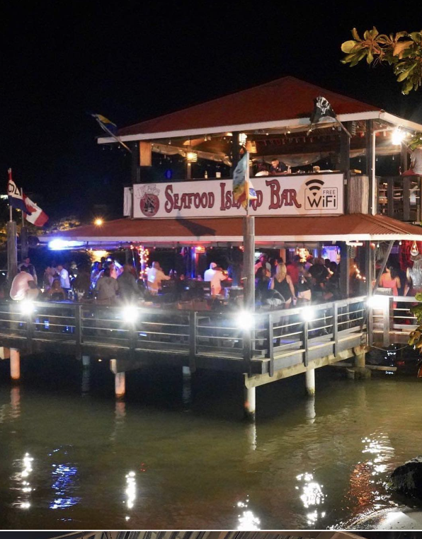 Captain Jack's bar buzzing with nightlife over the water in Roatan