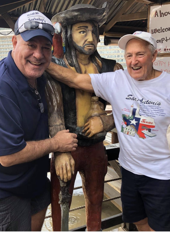 Guests posing with the Captain Jack statue at Captain Jack's Seafood Island Bar