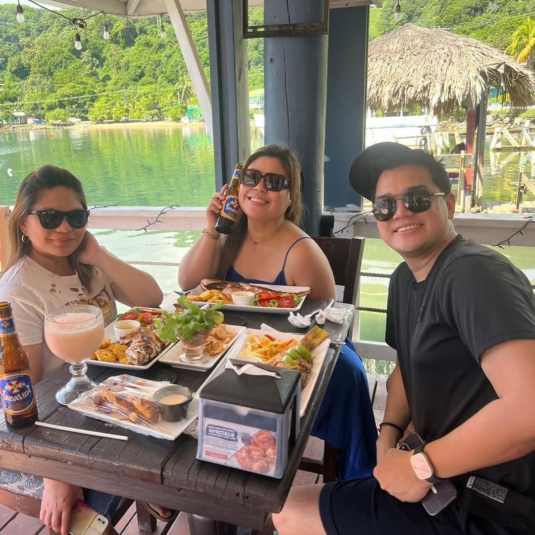 Friends enjoying fresh seafood and cold beers with an ocean view at Captain Jack's